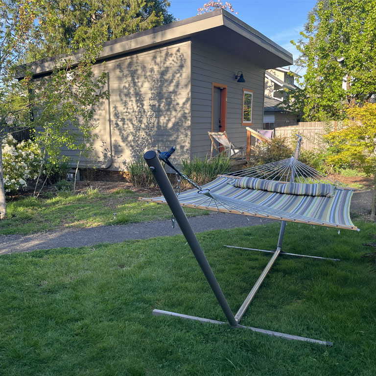 Exterior view of ADU with colorful hammock in forefront.